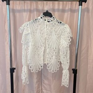 White appliqué ruffle blouse